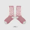1741 Calcetines infantiles al por mayor 2024 otoño e invierno nuevo estilo tejido inverso con borlas calcetines de media caña modernos algodón sin costuras calcetines para niñas