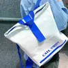 Sacola de papel DuPont com logo impresso personalizado, bolsa tote com zíper de ombro único e transversal, bolsa de mão para presente em estoque, bolsa à prova d'água para celular