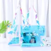 Bolso de mano con logo personalizado de PVC láser empaque de ropa bolso de mano de plástico transparente colorido bolsa de compras para regalo