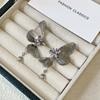 Pendientes de mariposa hueca tridimensionales con borla y circonita púrpura, estilo súper hada exquisito, moda para mujer, pendientes de temperamento de alta gama