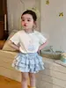 Dz26013 Traje para Niña 2026 Verano Bebé Niña Estampado de Dibujos Animados Camiseta de Manga Corta Top Falda de Tartaleta con Encaje a Cuadros