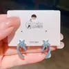 Exquisitos pendientes de estrella de cinco puntas estilo japonés y coreano con pequeños zircones azules, diseño coreano con un toque de lujo ligero