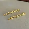 Pendientes de cadena de metal estilo europeo y americano con hebilla larga de herradura, pendientes colgantes de borla de latón para mujer, diseño de nicho de lujo ligero, nuevos para mujer