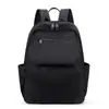 Mochila de tela de nailon ligera y duradera de color sólido con un tacto de alta gama, adecuada tanto para hombres como para mujeres, multibolsillos, mochila de gran capacidad para negocios y viajes.