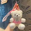 Venta especial peluche moda cool oso mochila escolar para estudiante muñeco llavero pareja linda dibujos animados pequeños regalos al por mayor