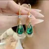 2025 Nuevos y Modernos Brazaletes para Oreja de Cristal Morado de Alta Gama con Forma de Gota, Aretes Sencillos y Elegantes, Accesorios para Oreja de Moda y con Estilo