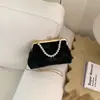 Bolso de metal para mujer con textura, nuevo, flor metálica, 2026, moda, simple, de noche, bolso de mano de perlas, bolso de hombro cruzado