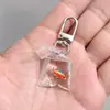 SHEIN TEMU Chaveiro Explosivo Peixe Dourado Transparente Peixinho Chaveiro de Resina Pingente de Joia Acessórios