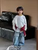 Camiseta Infantil Estilo Outono 2026, Camiseta Top Fashionável Estilo Coreano com Gola Redonda Estampada para Meninos, Branca de Manga Longa com Rosto Sorridente