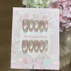Un par de puntas de uñas hechas a mano delicadas, con forma de corazón, de lunares rosas, con lazo de mariposa, estilo ojo de gato