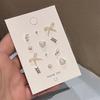 Pendientes de perlas súper dulces, elegantes y con lazo blanco, a la moda, que combinan con todo, con diseño de estrella y luna, mini pendientes para mujer.