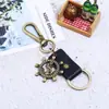 Llavero de coche de cuerda de cuero para pareja, hombres y mujeres, Aleación Timón creativo colgante de cuero suministro transfronterizo llavero de piel de vaca