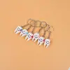 Atividade de abertura de clínica odontológica presente criativo pequeno presente dente dente tipo chaveiro modelo de dente pequeno pingente