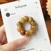 Mismo estilo que Xiaohongshu descompresión ajo grande intestino raíz de bodhi hilado a mano punta del dedo juego cultural artículo de mano para jugar con cuentas budistas pulsera de cuentas de oración femenina