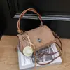 Bolso de mano casual elegante Shuai Mi Jia para mujer, nuevo modelo principios de otoño 2026, bolso cuadrado pequeño simple, bolso bandolera de moda