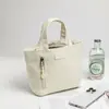 Mini Bolso 2026 Original Color Sólido Bolso de Mujer Resistente al Agua Pequeño Bolso de Tela Moderno Bolso de Maquillaje Simple de Mano E8