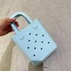 Bolsa de Gelatina 2026 Nuevo Modelo Transfronteriza DIY Bolsa Perforada Bolsa para Mujer Color Macarrón Cesta de Playa para Artículos de Tocador Bolsa de PVC