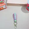 Llavero de cuerda de cuero con letra inglesa creativa, botella linda de arena movediza, muñeco de goma blanda, exquisitos accesorios del Joker al por mayor