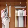 Colgador de ropa multifuncional de nueve agujeros para almacenamiento en el hogar, soporte para armario, popular colgador mágico giratorio retráctil plegable de nueve agujeros