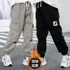 Pantalones de trabajo forrados de forro polar para niños, estilo primavera y otoño, pantalones largos cónicos, nueva colección primavera 2026, para niños mayores, pantalones deportivos de moda