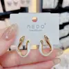 Pendientes de gota de esmalte geométrico de lujo ligero de estilo francés, elegantes, con diseño de moda, con sentido de celebridad de Internet, pendientes de pasador de plata, pendientes delgados con rostro distintivo.