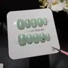 Onda Verde LecheRefrescante de VeranoUñas Postizas para un Look NaturalVerde Menta Claro con Puntos Verdes Claros y Estrellas Plateado-Negras