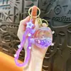 Llavero de despertador con aceite, figura pequeña linda transfronteriza, colgante de arena líquida lindo, accesorio para bolsa, regalo pequeño, venta al por mayor de comercio exterior
