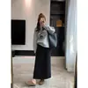 Falda de papel negra de otoño, falda de lana con caída, falda elástica casual de cintura alta con un ambiente relajado y elegante para mujer