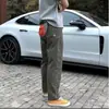 Pantalones casuales holgados cónicos funcionales de tres capas tipo softshell estilo americano con etiqueta blanca para hombres y mujeres, pantalones largos para hombres
