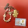 Llavero de tela con logo de empresa personalizado Cadena para teléfono móvil Angela Lámina de oro puro Oro 999 Regalo de aniversario