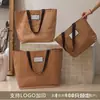 Bolsa de PP tejida de alta calidad bolsa de mano personalizada para tienda de ropa bolsa de mano engrosada bolsa de regalo para reunión anual de exposición cosida duradera