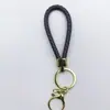 Venta al por mayor del fabricante Llavero de Cuerda de Aleación Tejida y Cuero Accesorios Colgantes Material PU Bolsas Pequeñas de Regalo Accesorios para Llaveros
