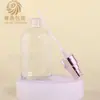 En Stock Botella Transparente Redonda de Hombros de 100 ml para Aceite Esencial, Botella de Vidrio para Loción de Esencia, Material de Empaque Cosmético de Vidrio con Gotero para Líquido Original