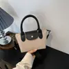 Bolsa de Bolitas de Hot Selling Transfronteriza 2025 Nueva Pequeña de Nicho Nylon para Mujer Bolso de Mano Versátil de Moda Bolso Cruzado