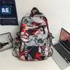 Mochila de graffiti de moda y genial en stock para hombres, bolsa deportiva ligera, mochila casual para laptop para estudiantes de secundaria, mochila para niñas de secundaria