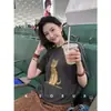 Camiseta de manga corta de algodón puro, estilo europeo, holgada y de talla grande para mujer, 2026 verano, top de camiseta juvenil de moda con dibujos animados de alta gama