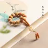 Pulsera de Palo de Rosa Natural, Cuentas Pequeñas Retorcidas a Mano, Anillo Giratorio con Núcleo de Oliva de León, Juguete para Aliviar el Estrés para Hombres y Mujeres, Cadena de Cuentas para Aliviar el Estrés en la Punta de los Dedos
