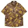 Camisa de Manga Curta com Estampa de Flor de Lírio Amarelo Brilhante em Gradiente Marrom Escuro, Fita com Padrão Sutil, Camisa Casual Fina e Solta para Homens e Mulheres