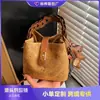 Bolso pequeño transfronterizo simple y versátil para mujer, nuevo modelo primavera 2026, bolso de un solo hombro cruzado madre-hija, bolso tipo cubo de alta gama