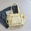 Bolso de lona de color liso transfronterizo nuevo, bolso de hombro de gran capacidad, bolso tote versátil para estudiantes, bolso de mano, bolso cruzado