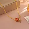 Pendientes de trébol de cuatro hojas del mismo estilo de la serie Wanxiang de la joyería de oro, pendientes y conjunto de collar de moda nicho de tendencia china exquisitos al por mayor