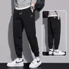 Pantalones deportivos cálidos con forro de felpa de marca de moda otoño e invierno 2026 para hombre, pantalones jogger holgados de color liso con cordón, pantalones largos para primavera