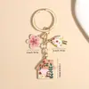 Llavero de hongo estilo cuento de hadas transfronterizo Temu, lindo colgante de aleación de casita con flor y aceite, decoración para bolso