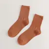 Meias novas femininas cor sólida algodão penteado japonês quatro estações meias cano alto preto e branco JK cor doce meias femininas simples atacado
