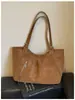 Bolso tote retro europeo y americano de nicho para mujer, principios de otoño 2026, gran capacidad, bolso versátil para el hombro y debajo del brazo con un estilo post-apocalíptico