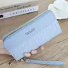 Cartera al por mayor estilo coreano para mujer, larga, estilo nuevo, patrón tejido, costura, cremallera, simple, gran capacidad, bolso de mano para comercio exterior para mujer