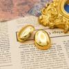 Aretes ovalados irregulares de viento frío europeo y americano, brillantes, de acero de titanio chapado en oro de 18k, aretes de viento de temperamento de nicho