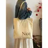 Bolsa de Lona com Estampa de Letras Estilo Coreano para Mulheres 2026 Nova Bolsa de Ombro Estilo Preguiçoso de Nicho Bolsa Tote Casual de Grande Capacidade