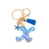 Llavero Colgante Temático Océano Azul con Borla de Estrella de Mar, Llavero de Resina Encanto para Bolso con 26 Letras