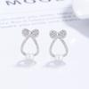 Clavo de oreja de perla con lazo de plata de ley 925 para mujer, diseño de personalidad, clavo de hueso de perla, joyería elegante de lujo inspirada en la oreja.